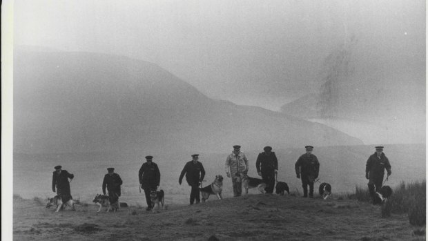 Police and sniffer dogs begin the grim hunt of Saddleworth Moor in 1986 for the remains of Pauline Reade and Keith Bennett, who vanished  21 years earlier.