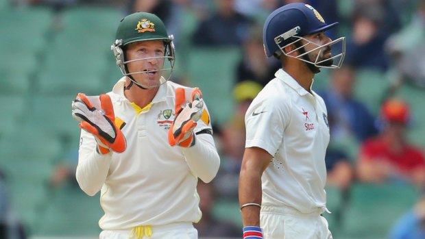 Brad Haddin exchanges words with Virat Kohli during day five of the third Test.