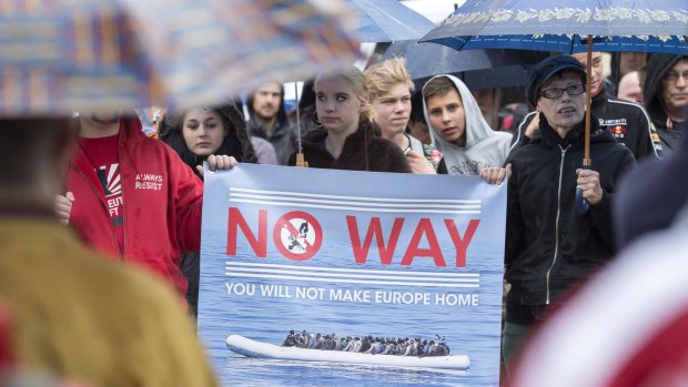 People take part at a demonstration initiated by the right-wing National Democratic Party against the German asylum law and asylum seekers in Riesa, Germany.