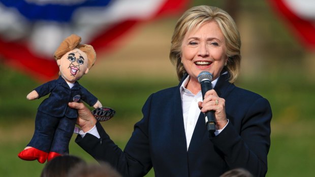 US Democratic presidential candidate Hillary Clinton holds up a doll that was handed to her from the audience on Wednesday.