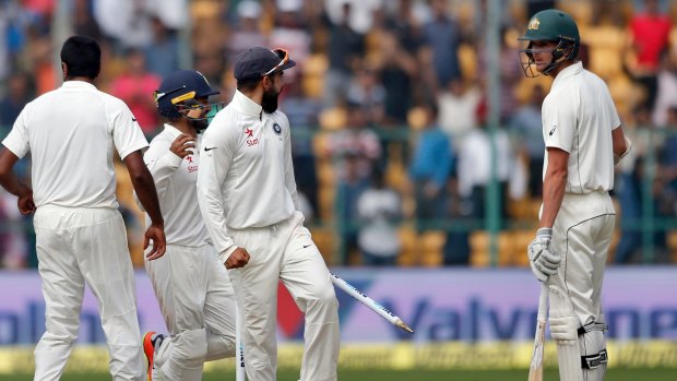India's captain Virat Kohli, second right, gestures to Australia's Josh Hazlewood after their win in the second Test.