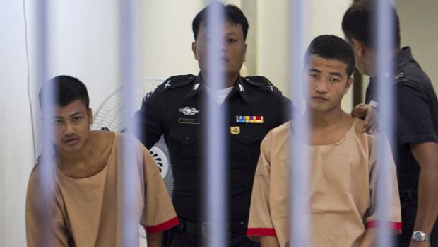 Myanmar migrants Win Zaw Htun, right, and Zaw Lin, left, both 22, are escorted by officials after their guilty verdict at court in Koh Samui, Thailand, on Christmas Eve.