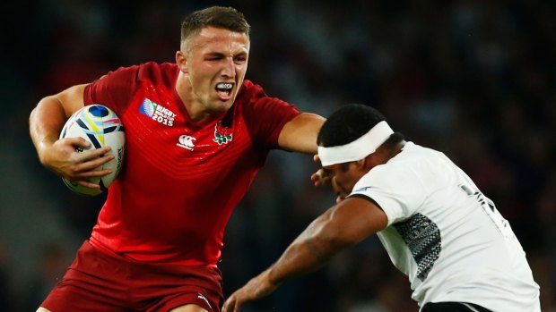 Strong arm: Sam Burgess on the charge against Fiji.