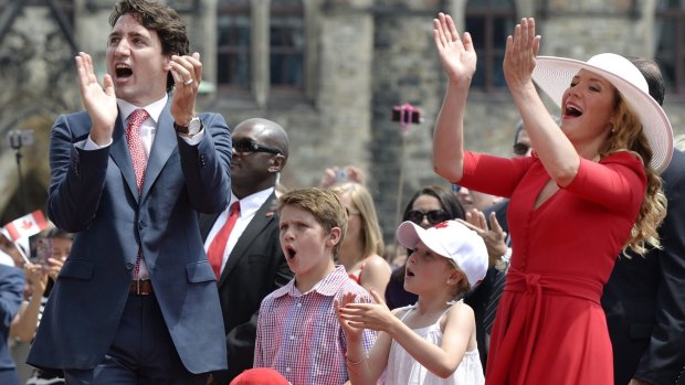 Canadian Prime Minister Justin Trudeau, his children Xavier and Ella-Grace, and wife Sophie Gregoire Trudeau cheer during Canada Day celebrations on Friday.