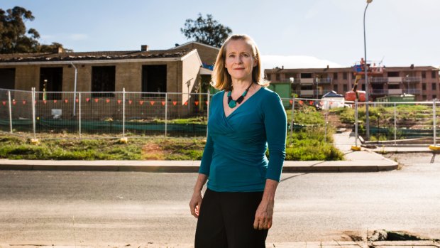 Melissa Bennett of the Red Hill Residents Group in front of the remaining Red Hill flats which are soon to be demolished.