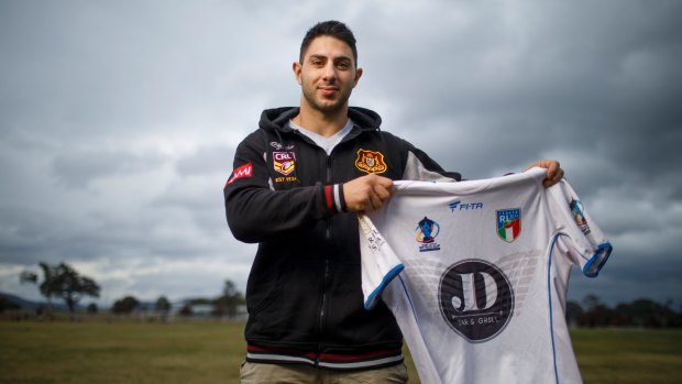 Former Gungahlin Bulls Rugby league player Anthony Onorato holds an Italian rugby league jersey belonging to Dragons forward and close mate Paul Vaughan. 