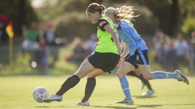 Canberra United striker  Caitlin Munoz slides one past the keeper during the 3-0 win.