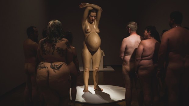 Art buffs take in Ron Mueck's 'Pregnant woman' at the National Gallery of Australia during a naked event at Hyper Real.