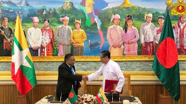 Myanmar's Union Minister Kyaw Tint Swe, right, shakes hands with Bangladeshi Foreign Minister Abdul Hassan Mahmud Ali after signing the deal in Naypyitaw.