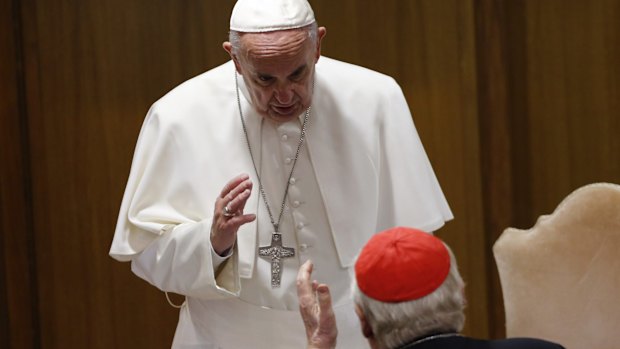 Pope Francis talks to a cardinal before the start of the afternoon session of the synod of bishops at the Vatican on Saturday.