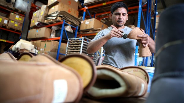 Made in Australia: Zeehan Khan glues together a boot in the Western Sydney factory of Australian Leather.