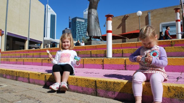 Zara (3) and Pippa (2) Harding enjoy the sunshine in the Perth Cultural Centre.