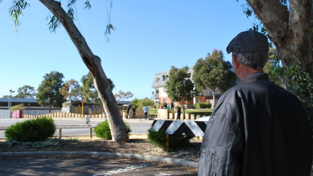 Local resident Pepi looks across the road to the building at which the man was injured.