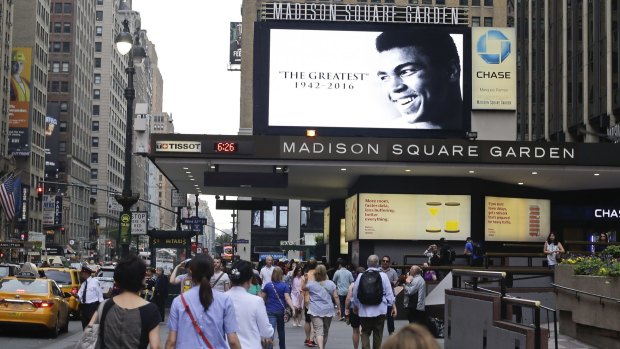Icon: Pedestrians pass the marquee in front of Madison Square Garden showing a tribute to Muhammad Ali.