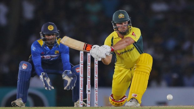Australia's Aaron Finch plays a shot against Sri Lanka as Kusal Perera watches.