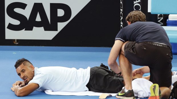 Injury scare: Nick Kyrgios is treated for an injury to his leg.