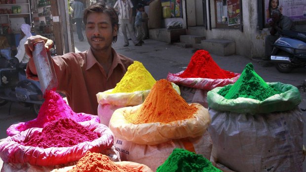 A man prepares colourful powder for sale in the market ahead of the Holi festival in Bhopal.