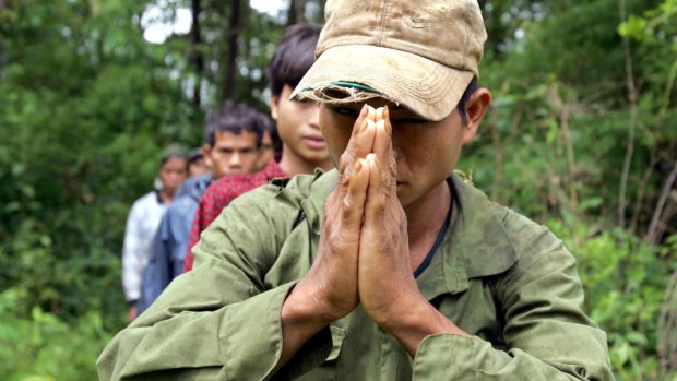 A Montagnard hill tribesman asylum seeker prays after emerging from dense forest in Cambodia's north-eastern province of Ratanakiri in 2004.