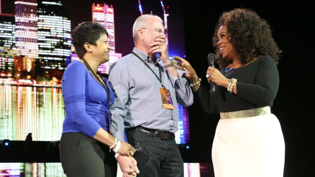Oprah brought the stunned newlywed couple on stage to give them an all expenses paid honeymoon during her Perth show. 