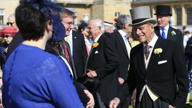 Prince Philip, right, speaks to guests during a garden party in the grounds of Buckingham Palace.