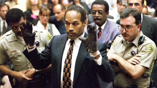O.J. Simpson tries on the blood-stained gloves alleged to have been used in the killing of Nicole Simpson and Ron Goldman.