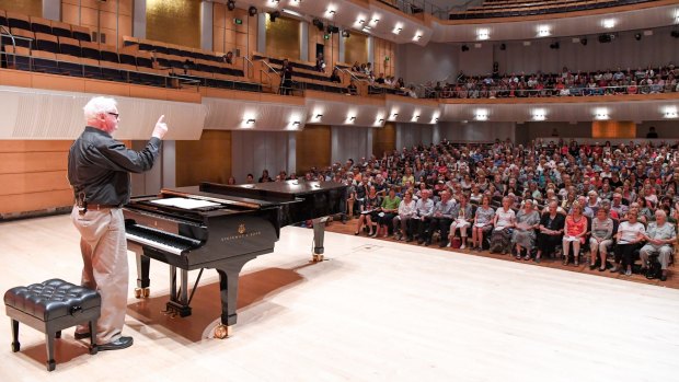 Conductor Richard Gill leads members of the Sydney Flash Mob Choir at the City Recital Hall.