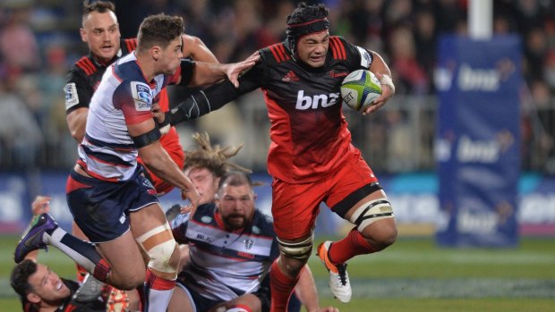 Trounced: Jordan Taufua charges forward for the Crusaders during their big win over the Rebels at AMI Stadium.