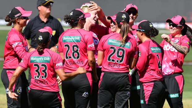 Class above: Sydney Sixers players celebrate another Adelaide wicket.