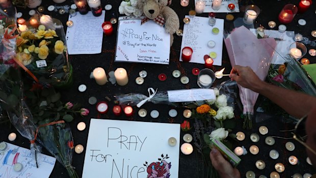 People lay tributes on the Promenade des Anglais on Friday evening in Nice.