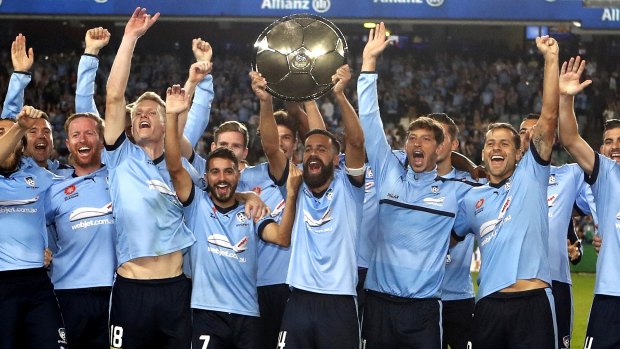 Winners are grinners: Sydney FC players celebrate with the Premiers Plate.