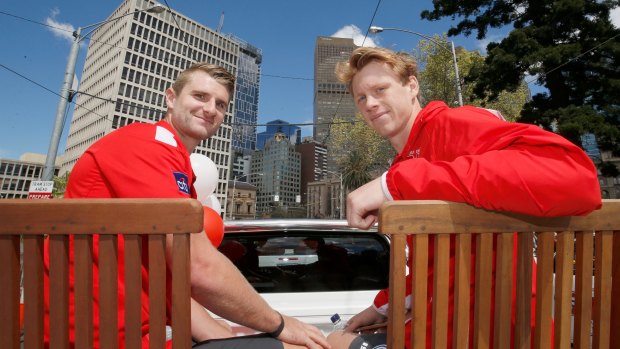 Taking it all in: Harry Marsh and Callum Mills take part in the 2016 AFL Grand Final Parade.