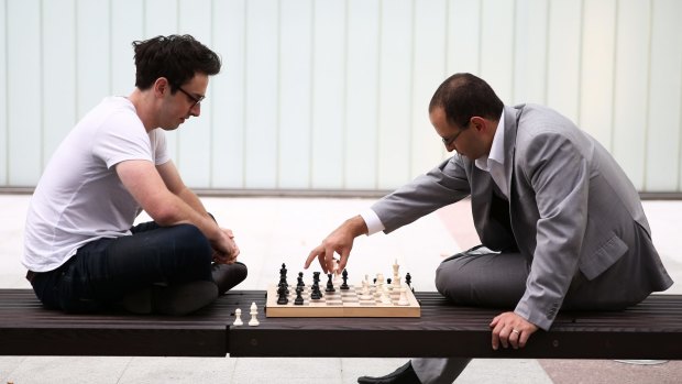 Michael Pettersson plays chess with former economics advisor to Arthur Sinodinos John Adams in 2015. 
