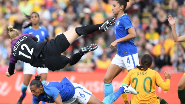 Acrobatic: Goalkeeper Daniele Neuhaus Turnes of Brazil pulls off a save.