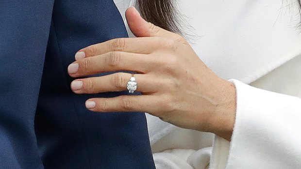 Britain's Prince Harry's fiancee Meghan Markle shows off her engagement ring. 