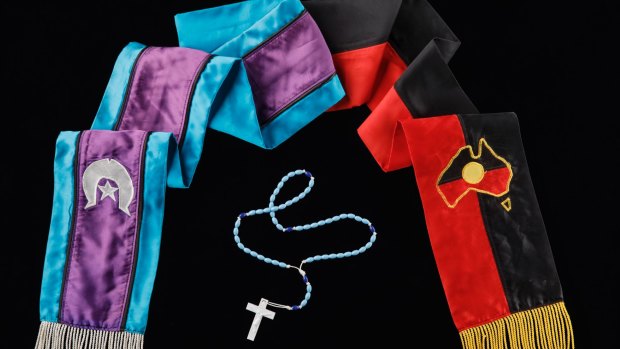 The ACT's Dion Devow chose a special University of Canberra graduation sash and rosary beads.