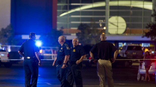 Police stand outside the cinema where a 'drifter' opened fire during a filming of <i>Trainwreck</i> in Lafayette, Louisiana.