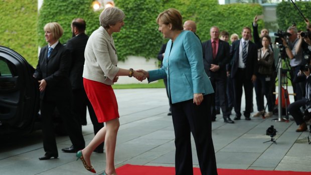 German Chancellor Angela Merkel greets British Prime Minister Theresa May before a meeting of European Union leaders at the Chancellery in Berlin.