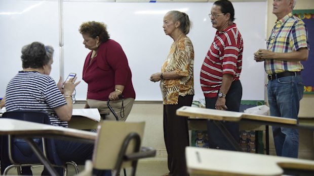 Residents line up to vote during a US election.