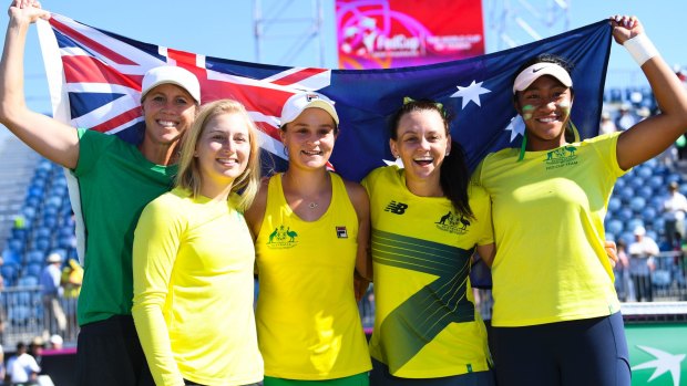 Australian Fed Cup team captain Alicia Molik, Daria Gavrilova, Ashleigh Barty, Casey Dellacqua and Destinee Aiava celebrate Australia's win over Ukraine at the Canberra Tennis Centre.