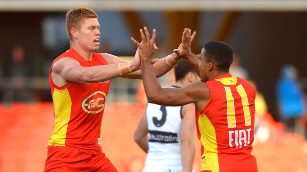 Peter Wright celebrates a goal with teammate Touk Miller.