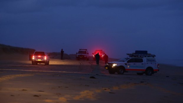 Police at the scene where two bodies washed up on Stockton Bight.