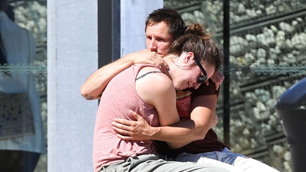 A couple comfort each other outside the Pasteur hospital on July 16, 2016 in Nice, France. 