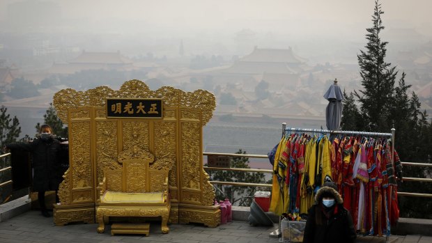 A vendor wearing a protective face mask waits for customers at the Jingshan Park in Beijing.