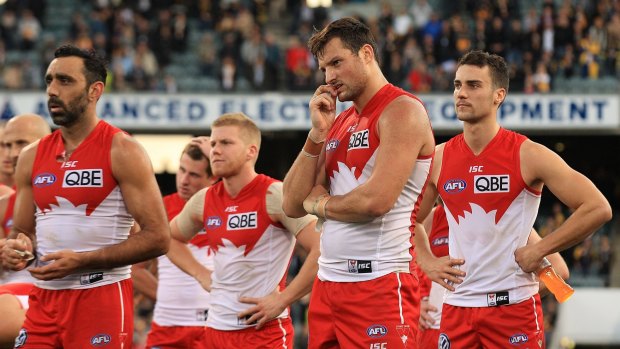 Ruffled feathers: Swans players look on after their big defeat.