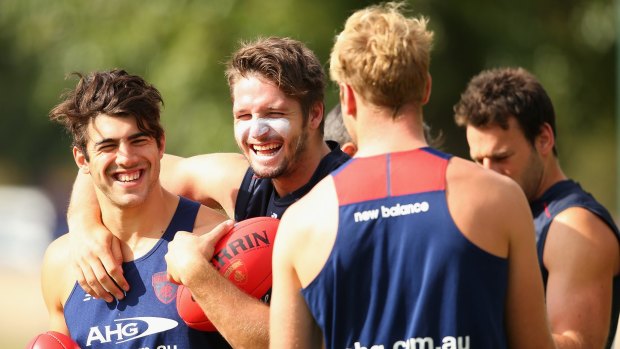 Team spirit: Demons Christian Petracca, Jesse Hogan and Jack Watts have a laugh during a training session at Gosch's Paddock.