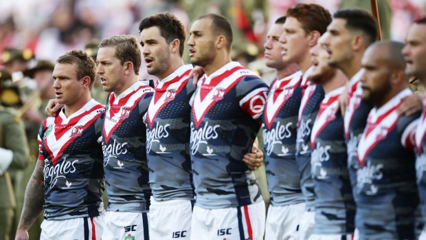 United: The Roosters line up for Anzac Day commemorations before the match against the Dragons at Allianz Stadium.