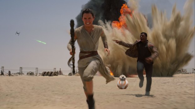 Under attack: Daisy Ridley as Rey and John Boyega as Finn in <i>Star Wars: The Force Awakens.</i>