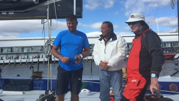 Syd Fischer (in red) on the deck of Ragamuffin 100  with sailing master David Witt (in blue) and Cruising Yacht Club of Australia commodore
John Cameron (in white).
