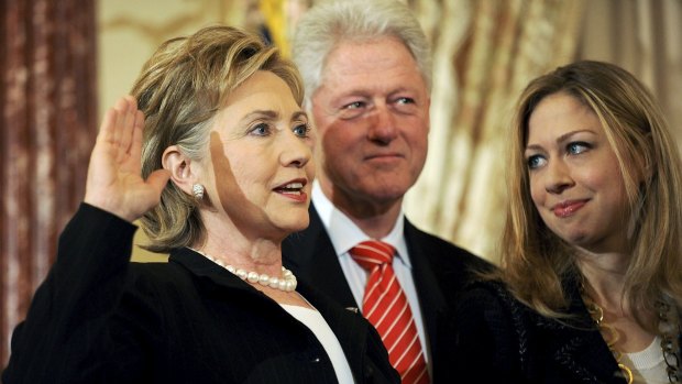 Then US Secretary of State Hillary Clinton (L) is joined by her husband former U.S. President Bill Clinton and daughter Chelsea Clinton as she is ceremonially sworn in at the State Department in Washington, in February 2009.