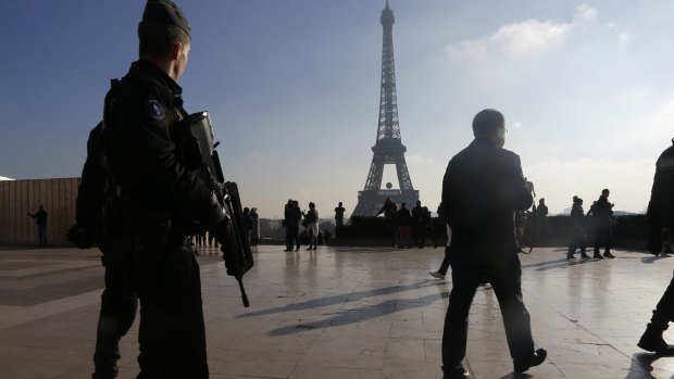 French police officers patrol near the Eiffel Tower after the Paris attacks.